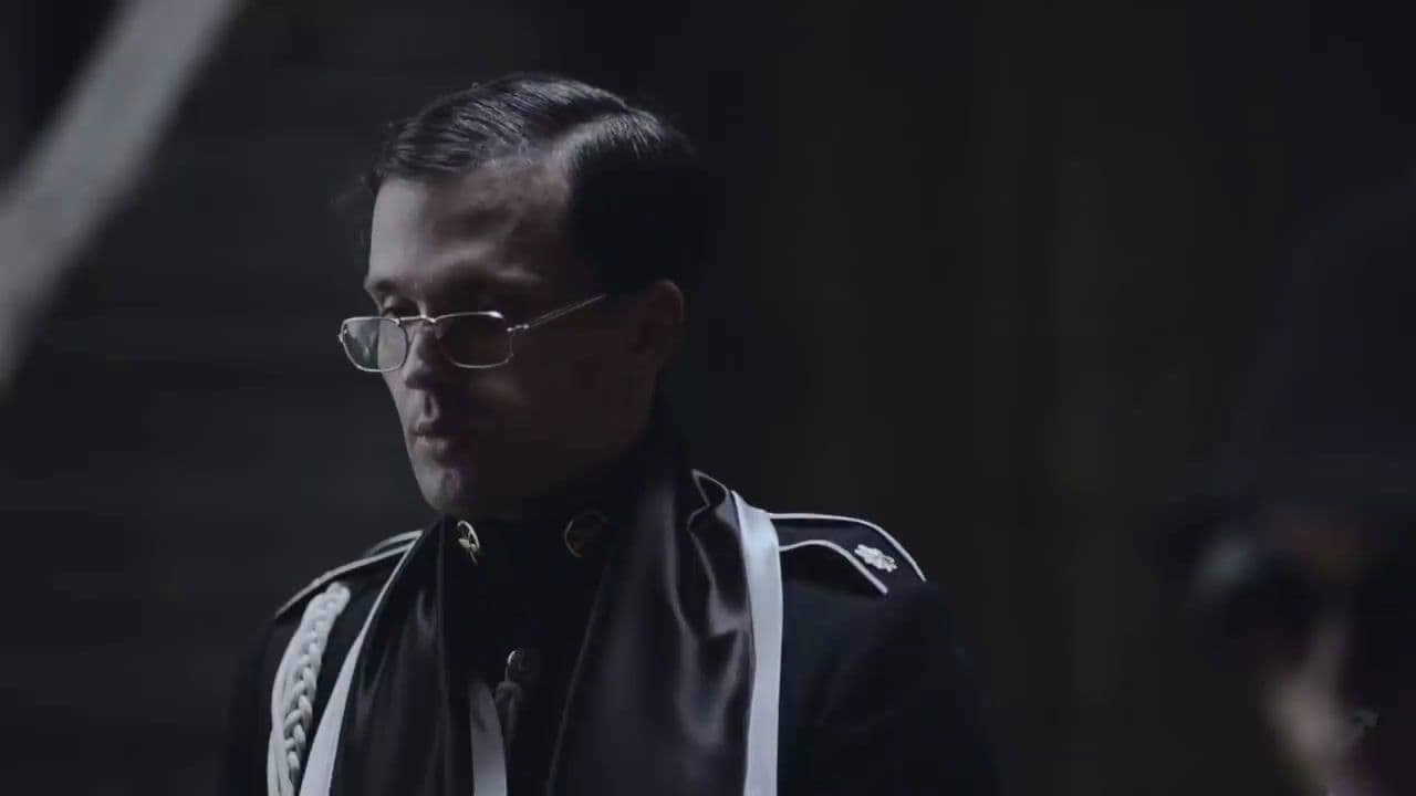 a man wearing glasses and a leather jacket
