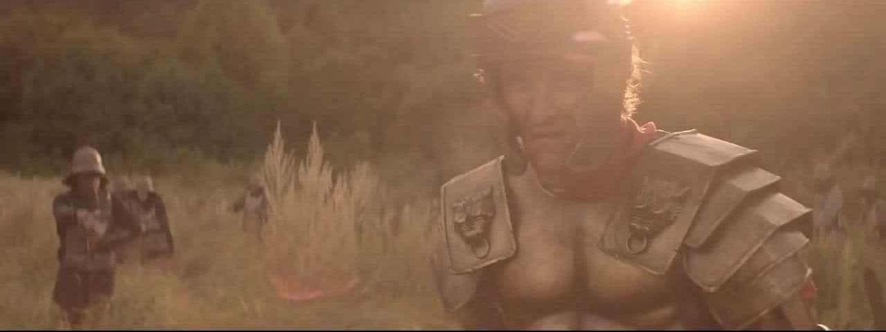 a man in armor standing in a field