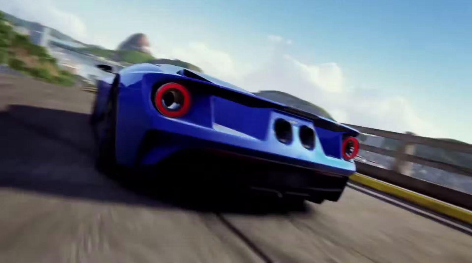 a blue sports car driving down a road