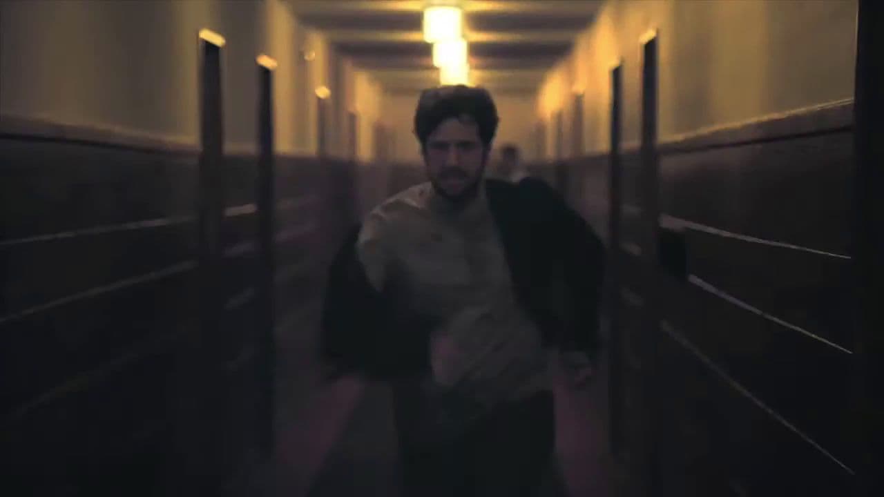 a man walking down a hallway in a building