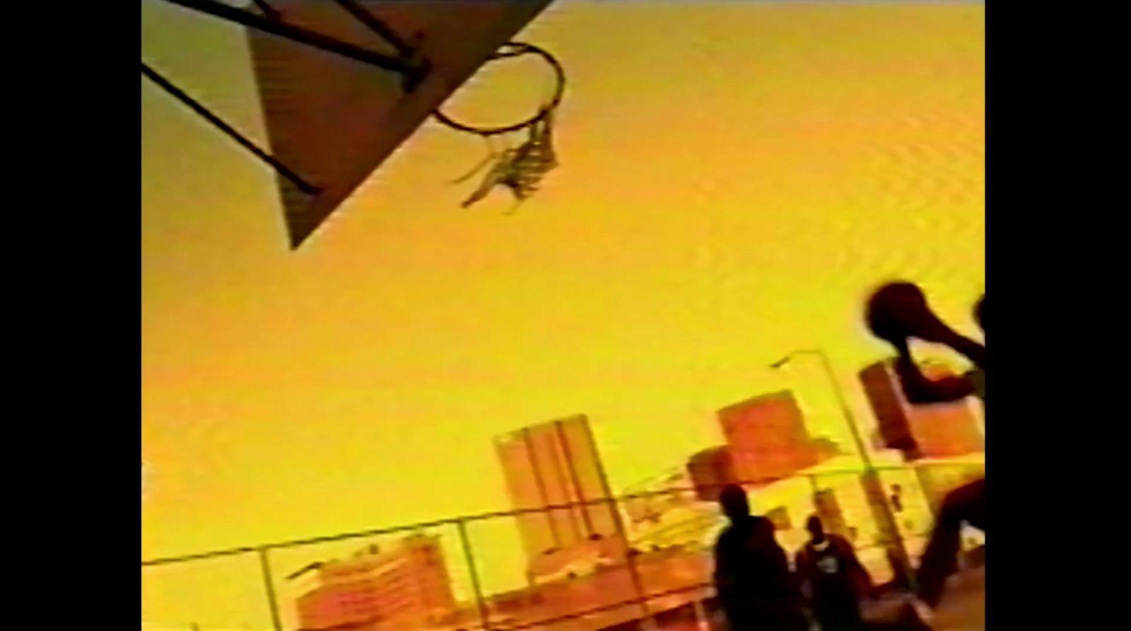 a man is doing a trick on a basketball hoop
