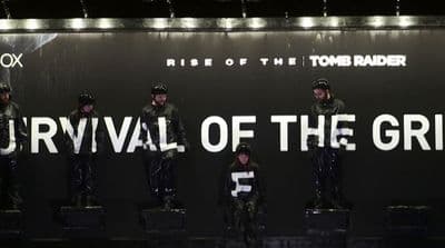 a group of people standing in front of a sign