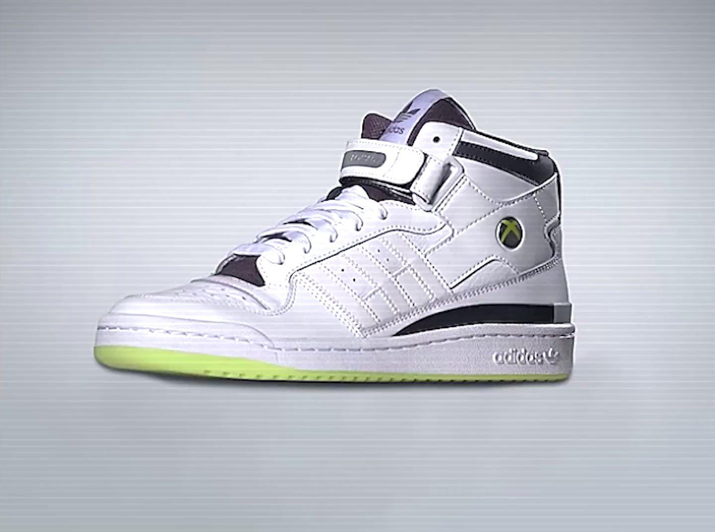 a pair of white and black sneakers on a gray background
