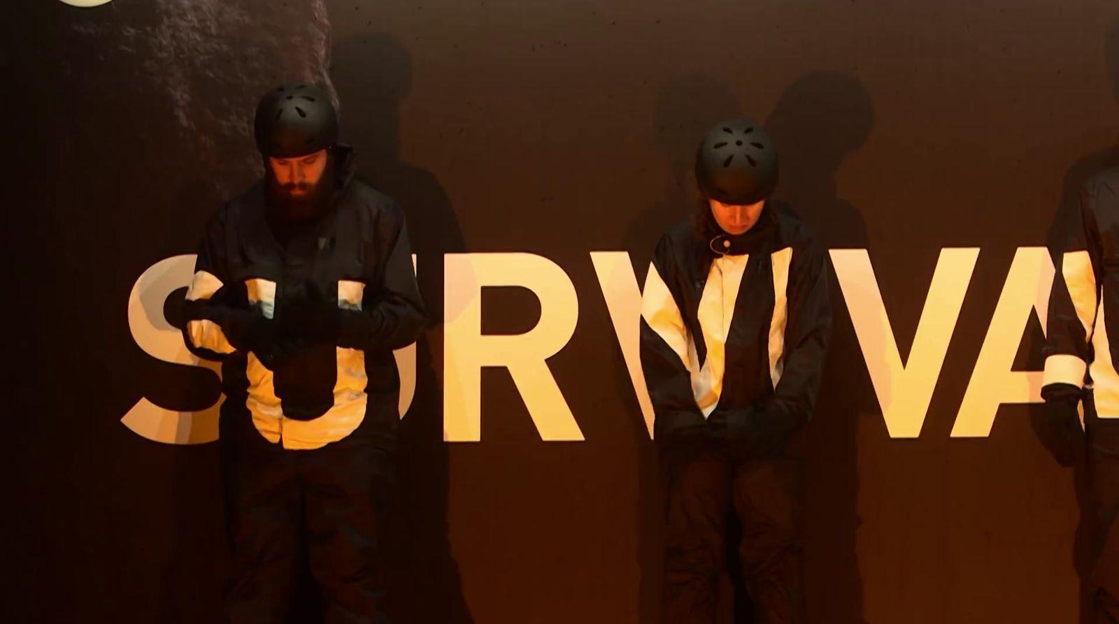 a group of men standing next to each other in front of a sign