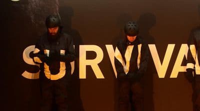 a group of men standing next to each other in front of a sign