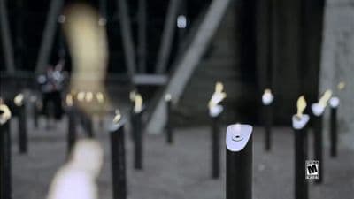 a group of black and white poles sitting on top of a sidewalk