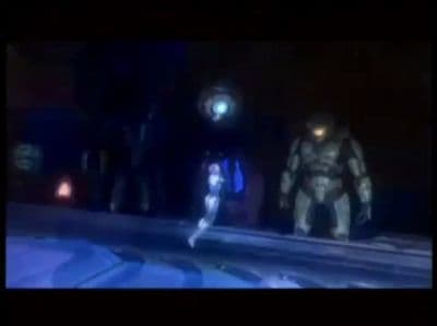 a woman standing next to a giant robot in a dark room