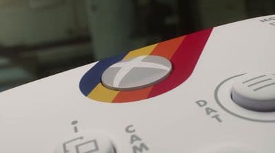 a close up of a remote control with a blurry background