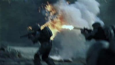 a group of soldiers with guns in front of a fire