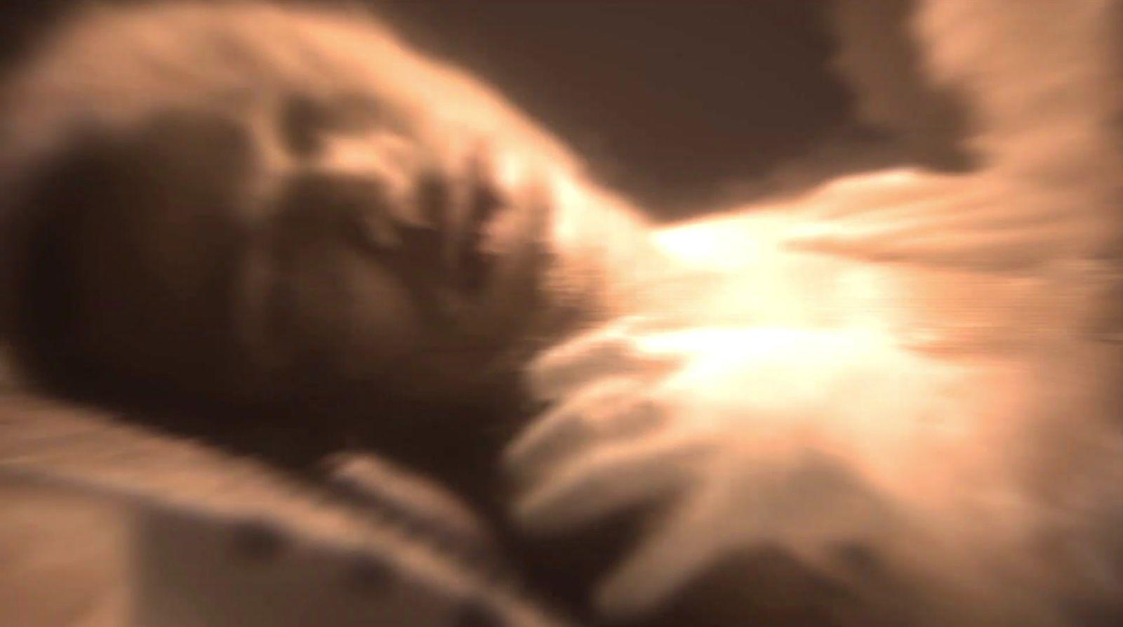 a blurry photo of a cat sleeping on a bed