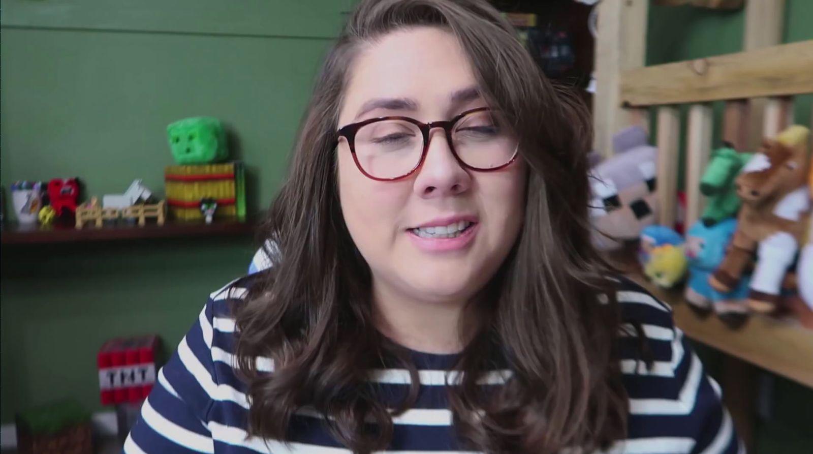 a woman wearing glasses and a striped shirt