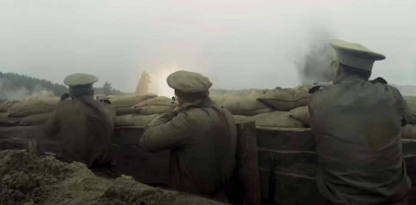 a group of men standing next to a pile of sand