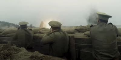 a group of men standing next to a pile of sand