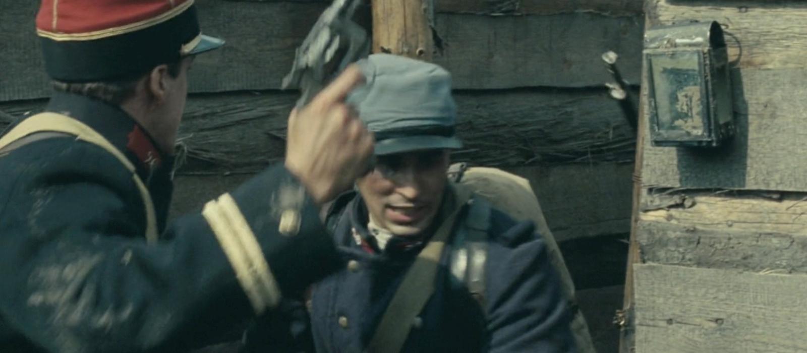 a man in a uniform talking to another man