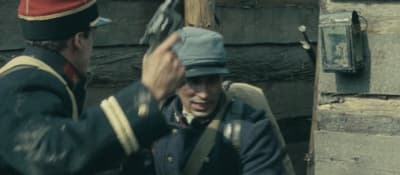 a man in a uniform talking to another man