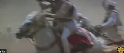 a blurry image of a man riding a horse