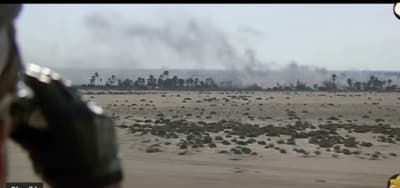 a large amount of smoke is coming out of a field