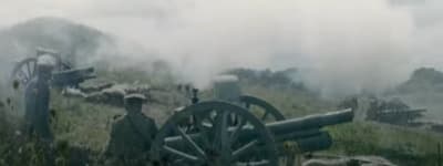 a group of men standing next to each other near a cannon