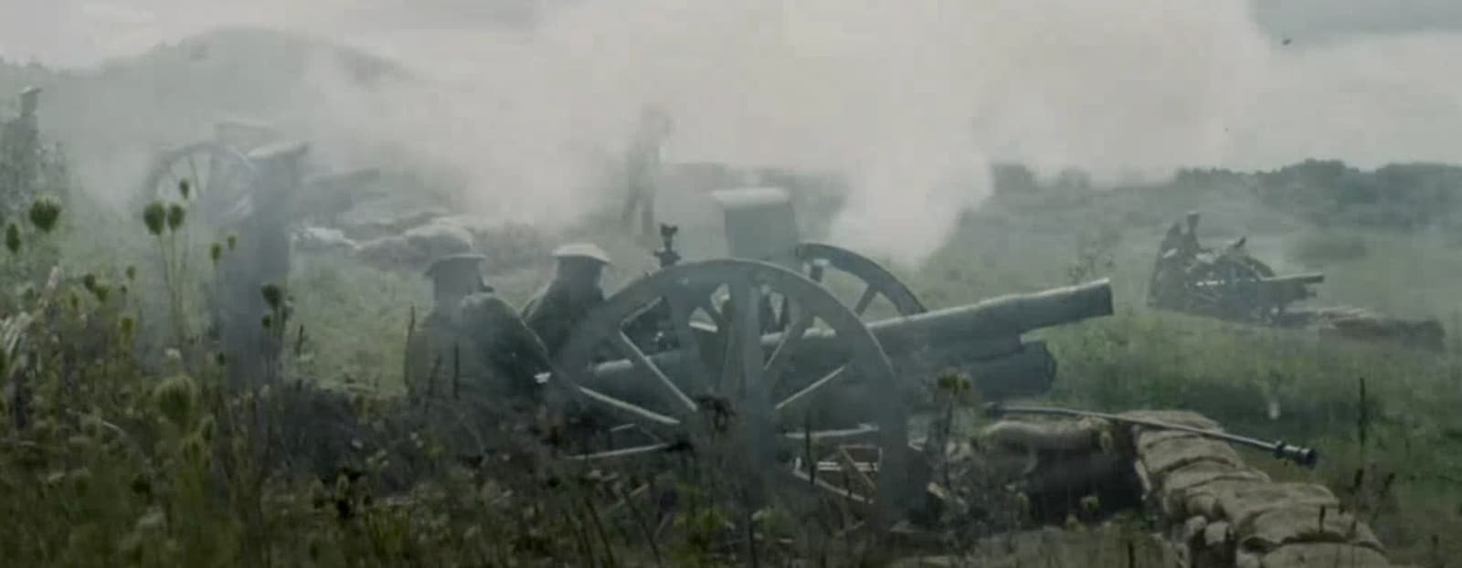 a group of men standing next to a cannon
