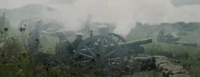 a group of men standing next to a cannon
