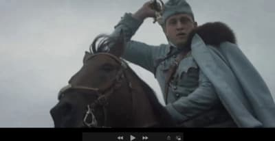 a man riding on the back of a brown horse