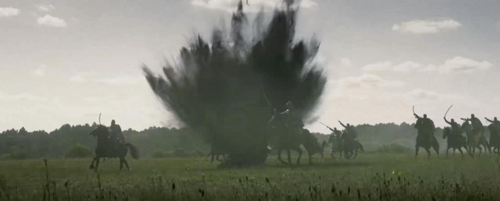 a group of people riding horses in a field