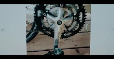 a close up of a bike's gear on a wooden floor