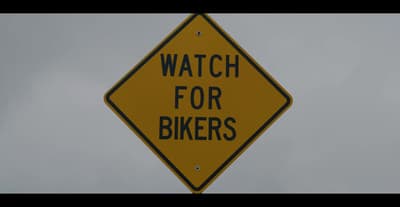 a yellow sign that says watch for bikers