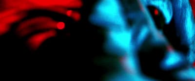 a blurry photo of a woman's face with a red background