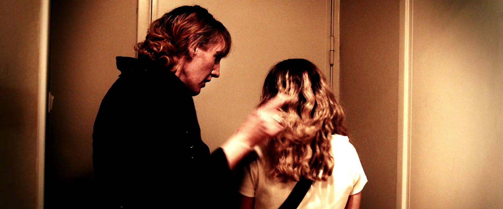 a man standing next to a woman in a hallway