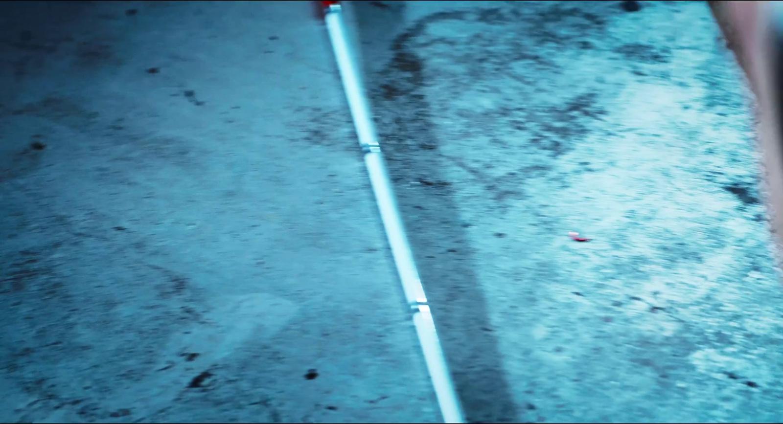 a metal pole laying on the ground in the snow