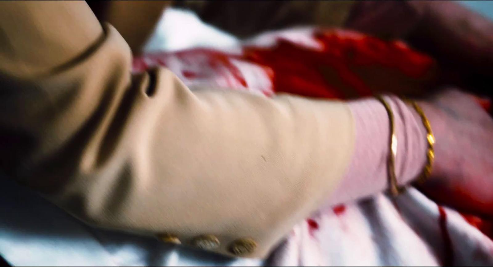 a person in a pink dress holding onto a red object