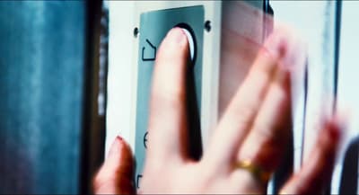 a woman's hand is touching a door handle