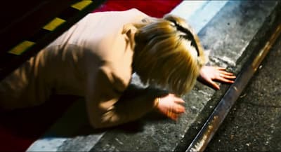 a woman bending over on the ground with her hand on the ground