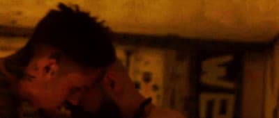 a man with dreadlocks talking on a cell phone