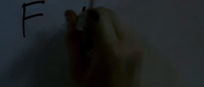 a person writing on a wall with a pen