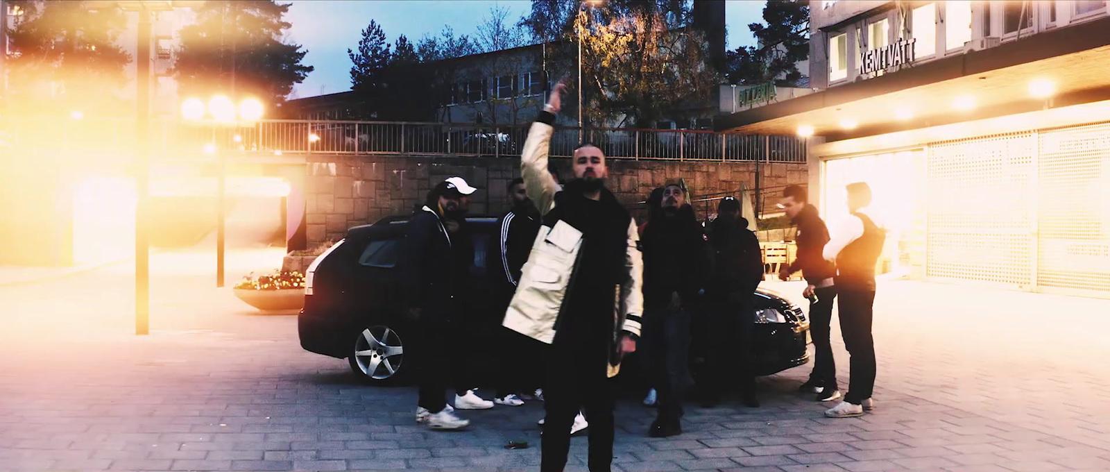 a group of people standing around a car