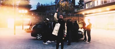 a group of people standing around a car