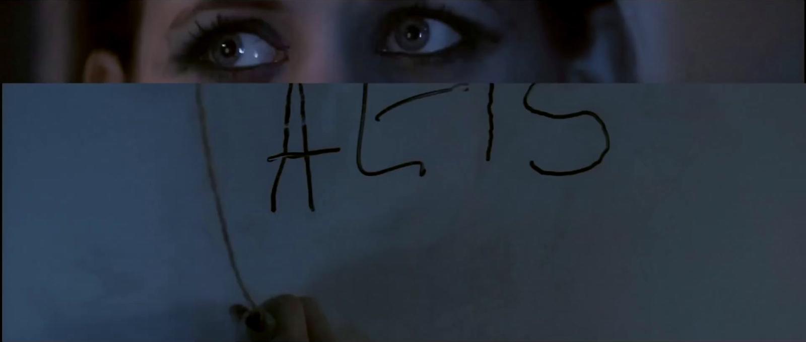 a woman holding a piece of paper with writing on it