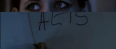 a woman holding a piece of paper with writing on it