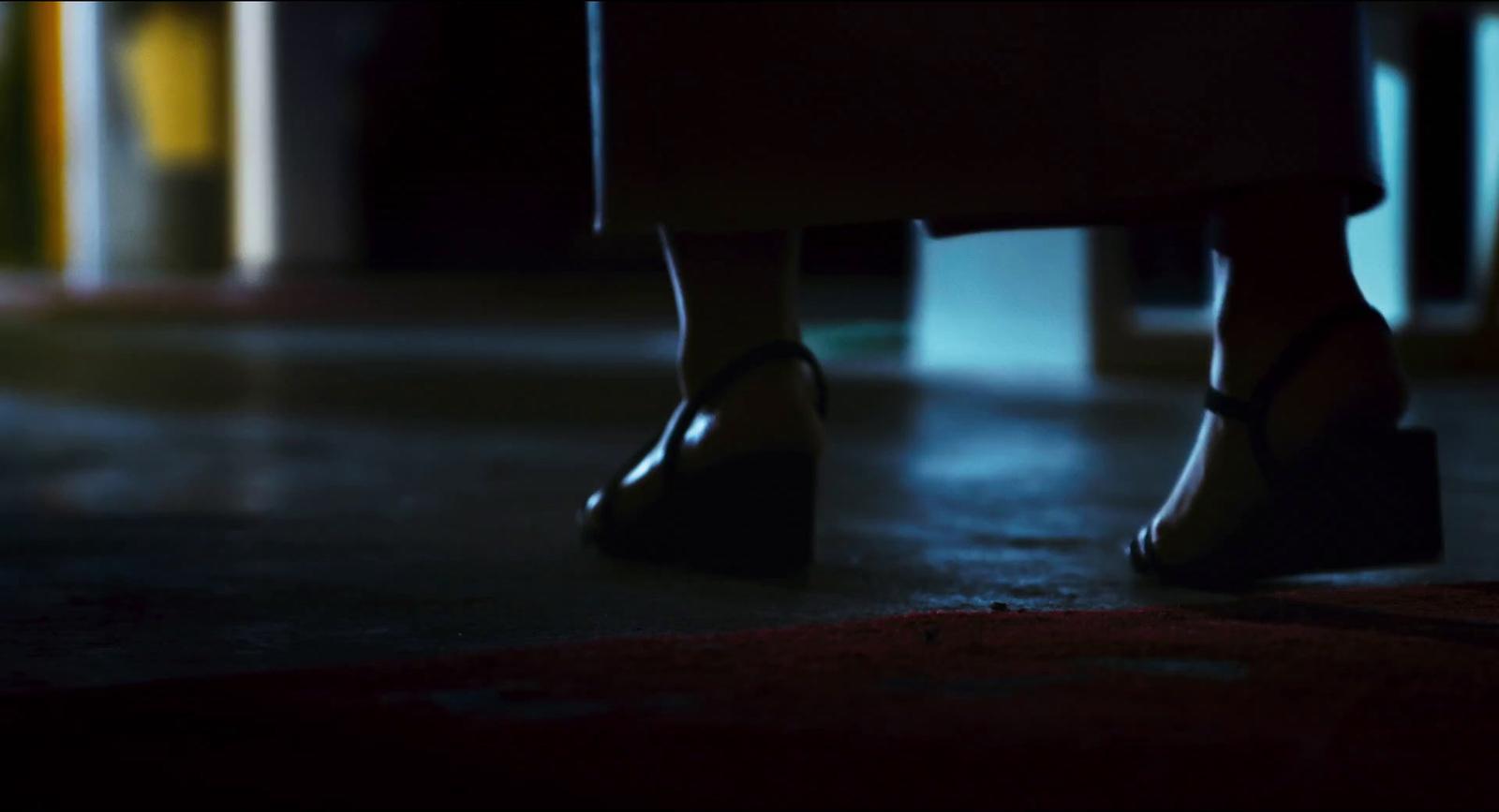 a close up of a person's legs wearing high heels