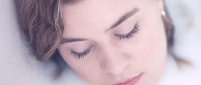 a close up of a woman with her eyes closed