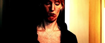a woman with red hair wearing a black jacket