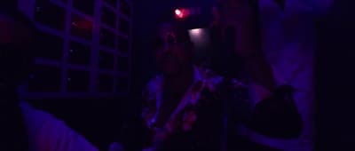 a man is taking a picture of himself in the dark