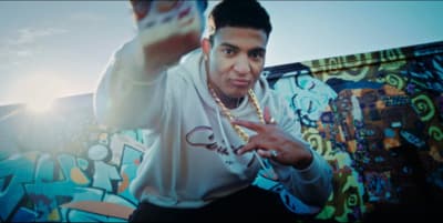 a man in a white shirt and some graffiti