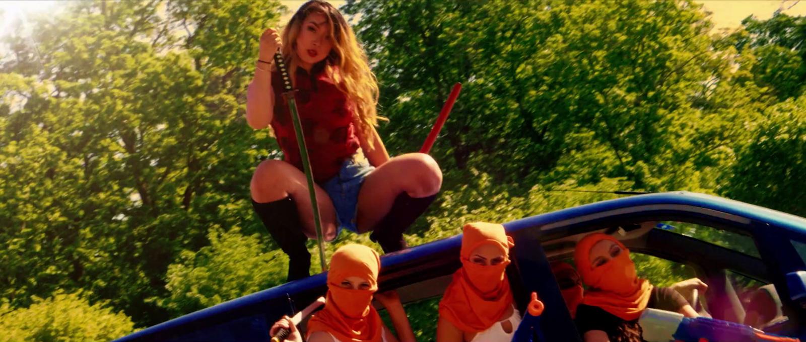a group of people riding on the back of a blue truck