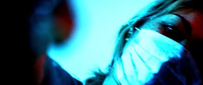 a woman with a mask covering her face