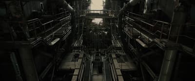 a very tall industrial building with lots of pipes