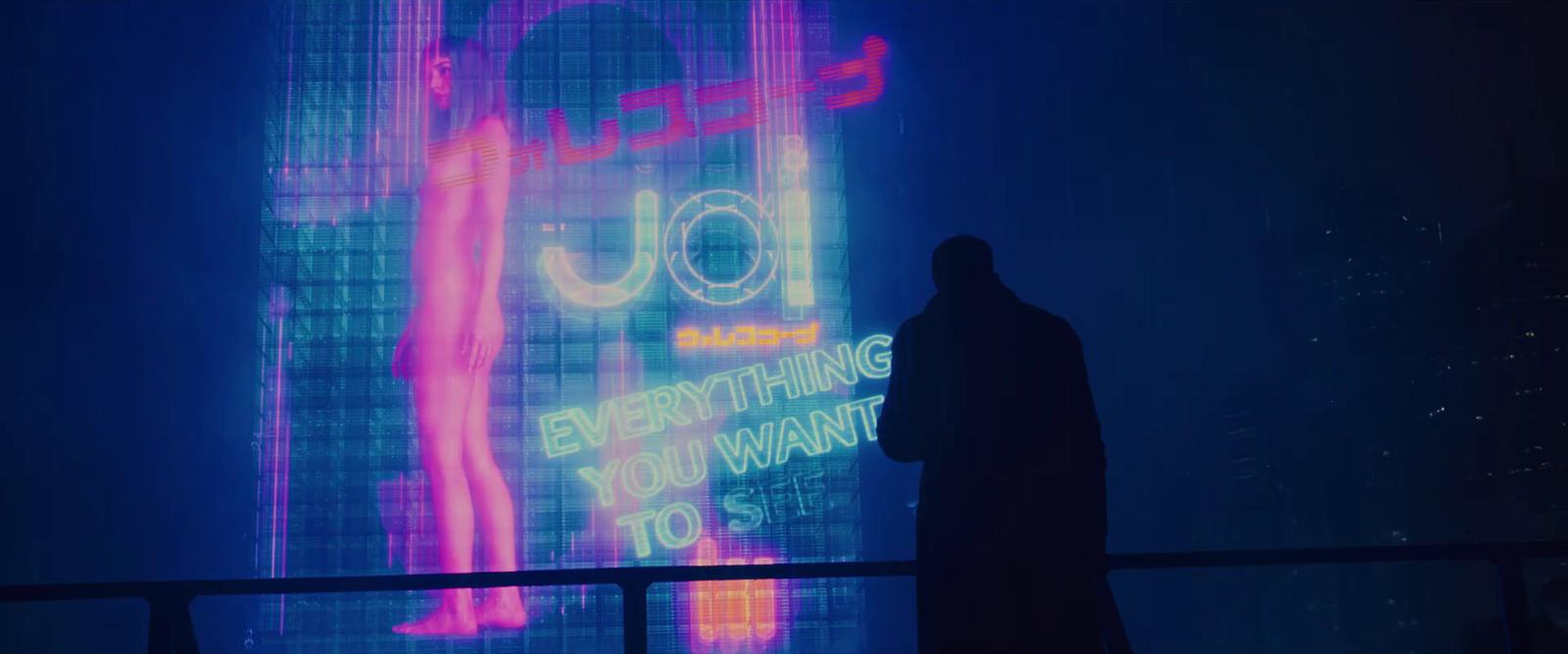 a person standing in front of a large screen