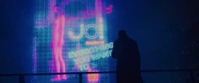 a person standing in front of a large screen